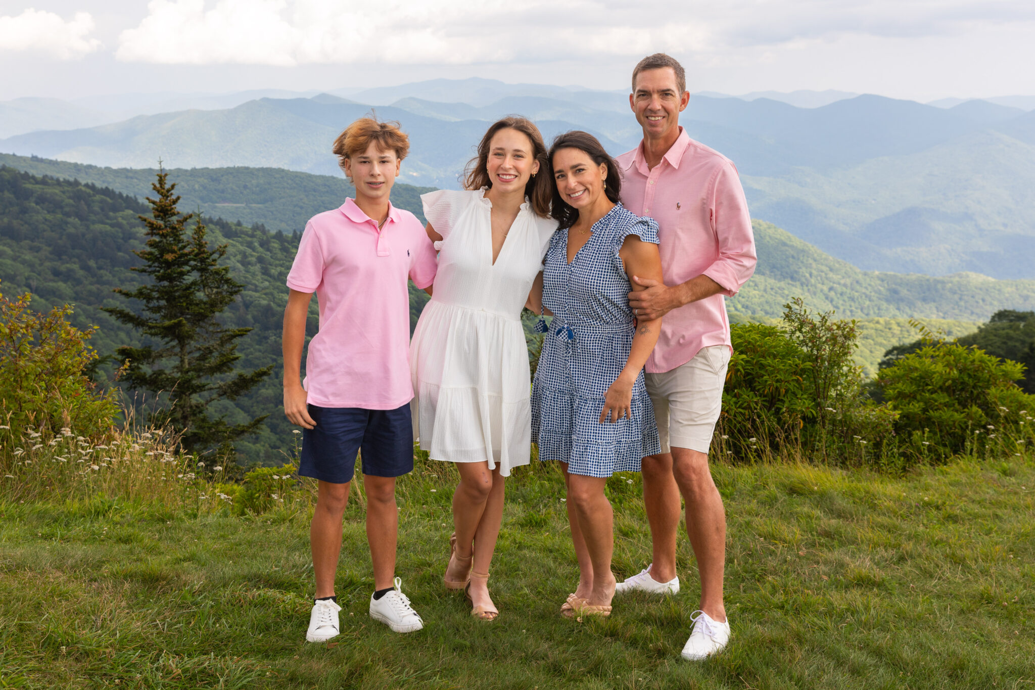 Asheville Family Portrait of 4 people standing in front of a mountain backdrop