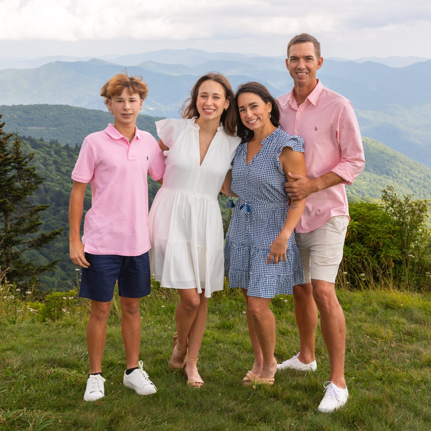 Asheville Family Portrait of 4 people standing in front of a mountain backdrop